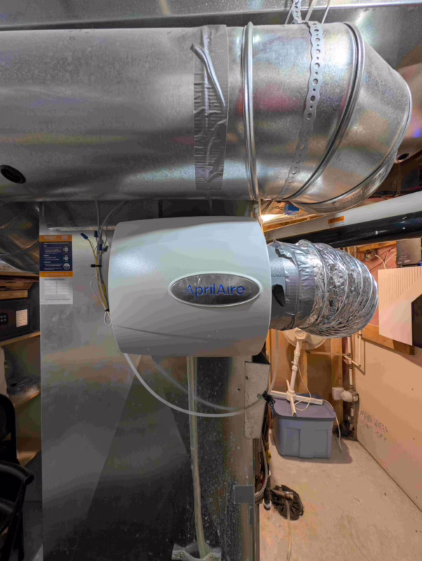 HVAC tech leveling new Aprilaire humidifier.