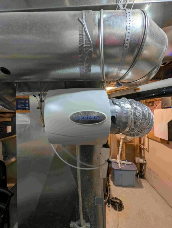 HVAC tech leveling new Aprilaire humidifier.
