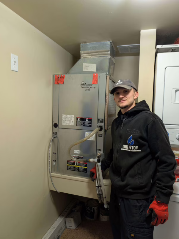 HVAC technician with new ClimateMaster boiler in Calgary.
