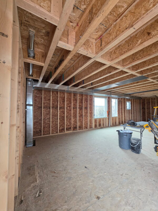 Long runs of custom fabricated HVAC ductwork installed across ceiling joists.