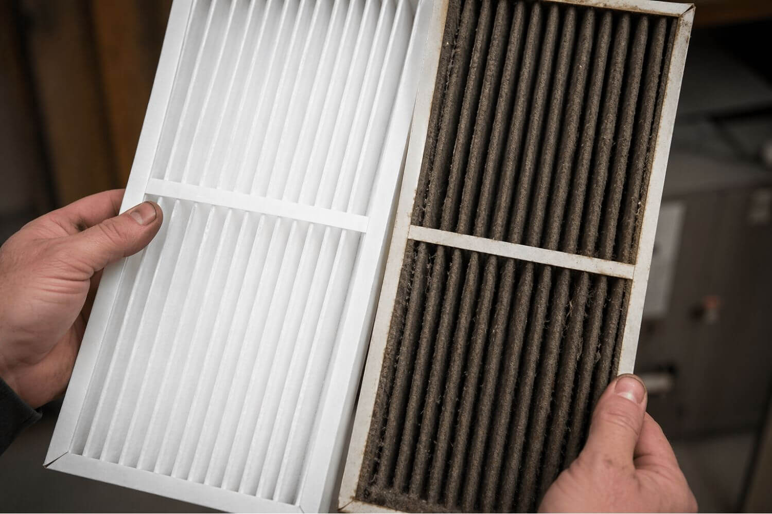Comparing a dirty, dust-filled winter furnace filter to a brand new clean replacement for spring HVAC preparation.