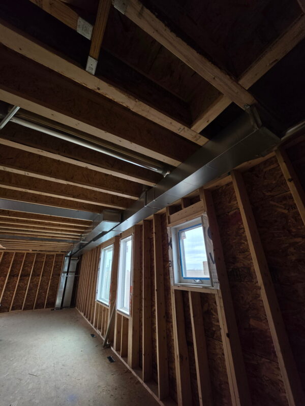Exposed custom ventilation ducts expertly routed through a new construction project in Calgary.