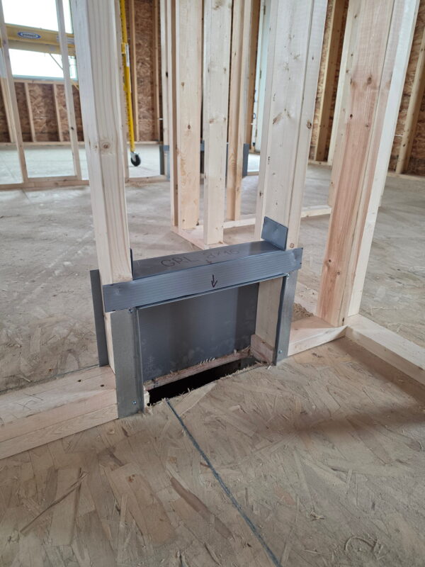 Close-up view of precision-fitted custom sheet metal ductwork for floor vents.